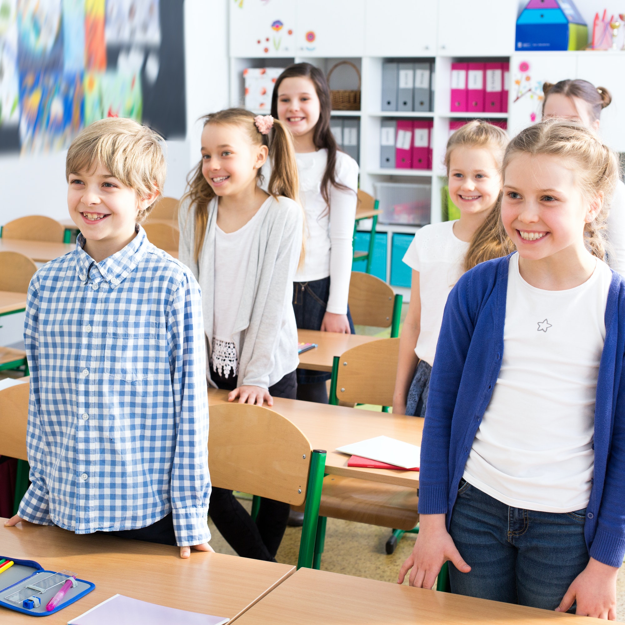 Children standing by school benchs