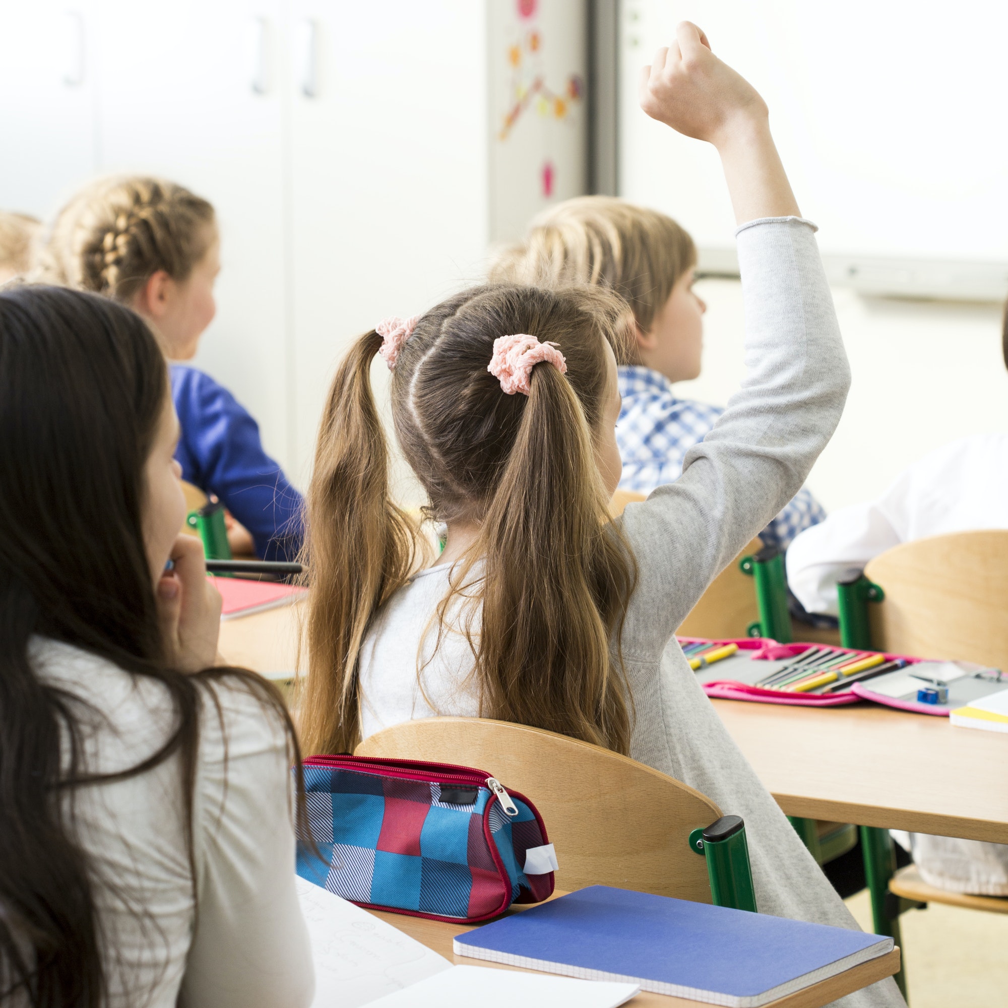 Girl raising her hand in school